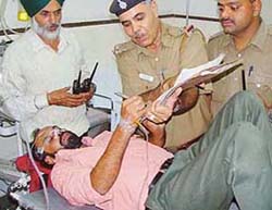 A policeman records the statement of Rajinder Raj, who allegedly consumed some poisonous substance in the court of the Chief Justice, Punjab and Haryana High Court