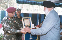 R.S. Jamwal, Station Commander, Jammu, presents the badge of sacrifice to Mr Suchet Singh, father of the Late Maj Manmeet Singh