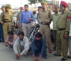 Members (sitting) of a gang of automobile thieves