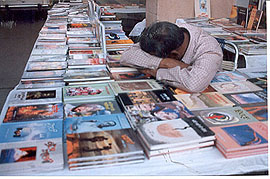 A bookstall owner sleeps during the book fair 