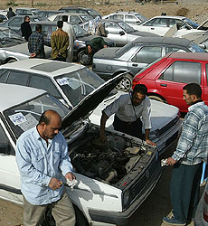 Customers and vendors swarm a Baghdad used car market