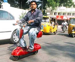 A two-wheeler from China which runs on solar power and battery being tried by an enthusiast in Hyderabad on Tuesday. 