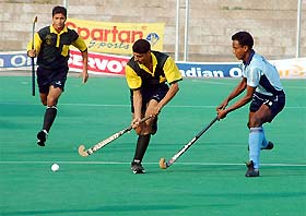 Players of Signals and Surjit Academy run for the ball in a knockout match of the 20th Indian Oil Surjit Hockey Tournament