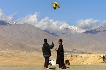 Afghan boys fly a kite in Kabul on Wednesday. The Taliban had banned kite flying