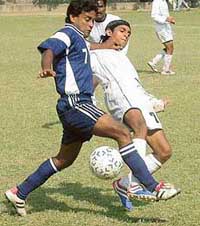 Ranjan Chaudhary of Allahabad Bank tackles a soccer player from Bank of India in the Banks Olympiad Football Meet at the Football Ground, Sector 17