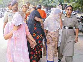 The women, who operated a commercial sex network, come out of the district courts complex in Chandigarh on Thursday
