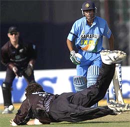 Indian batsman Mohammad Kaif watches as New Zealand bowler Kyle Mills attempts a catch off his own bowling 