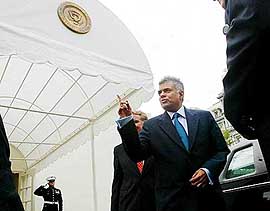 Sri Lankan Prime Minister Ranil Wickremesinghe gestures before getting in his vehicle