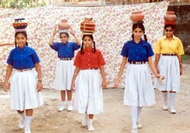 Girls of SKSK Educational Institute take part in a matka race during an athletic meet 