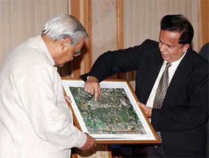 ISRO Chairman J. Madhvan Nair shows the first set of pictures taken by a new satellite