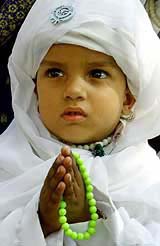 A Sikh girl prays near the Golden Temple