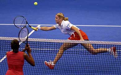 Kim Clijsters of Belgium returns a shot