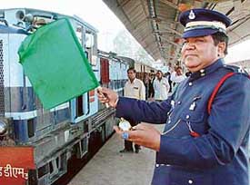 Wearing a dress of the erstwhile North-Western Railways, a guard flags off the Kalka-Shimla train at Kalka Railway Station on Saturday.