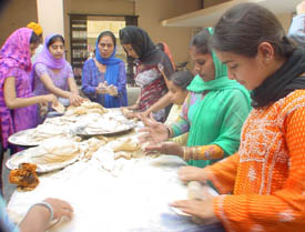 Devotees prepare langar at a gurdwara