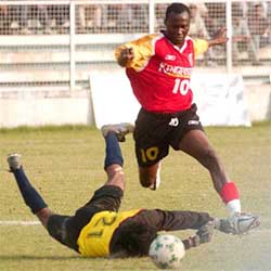 Mike Okoro  of East Bengal dribbles past Air India goalkeeper Raju Ekka to score the third goal for his team