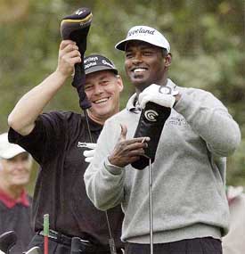 Vijay Singh and Darren Clarke share a joke on the second tee box 