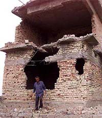 Jamal Mohammed looks over a house destroyed during an attack by US forces in the town of Tikrit