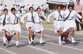 Students of Ajit Karam Singh International Public School, Sector 41, participate in three-legged race on the schools Sports Day at the Sports Complex