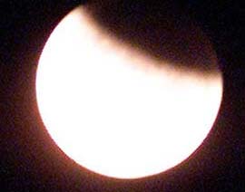 The moon as it enters the earth's shadow during total lunar eclipse on early Sunday morning