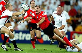 Mark Jones (C) of Wales passes the ball during their quarterfinal match against England