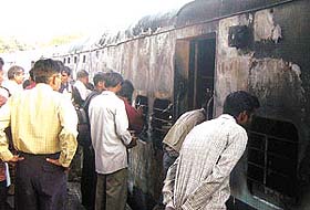 The empty coach of a stationary train, which caught fire at the Old Delhi Rly Station in the Capital