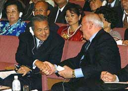 Former Malaysian Prime Minister Mahathir Mohamad (left) is greeted by former Soviet leader Mikhail Gorbachev