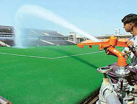 Water being sprinkled on the newly laid Astro Turf at Sector 42 Hockey Stadium in Chandigarh on Tuesday.