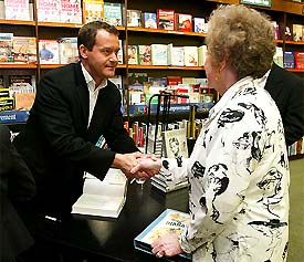 Paul Burrell (left), former butler and confidant of Princess Diana, greets fan Florence Quinn, the first in the line to have a copy of his book, A Royal Duty