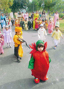 Children in fancy dresses hold a procession in connection with Childrens Day in front of the Nursery and Daycare Centre, PAU, Ludhiana
