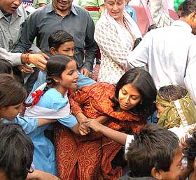 Actresses and social workers Nandita Das and Nafisa Ali with a group of slum children at a function to celebrate Children's Day in Yamuna Pusta 