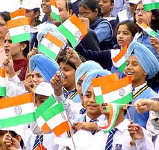 Schoolchildren wave the Tri-colour to greet President A.P.J. Abdul Kalam during the formal inauguration of India International Trade Fair 2003 at Pragati Maidan in New Delhi 