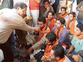 Prof K.N. Pathak, Vice-Chancellor, offers juice to students who ended their dharna against the fee hike at Panjab University on Sunday