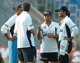 Coach John Wright gives tips to Sourav Ganguly, Sachin Tendulkar and Rahul Dravid during a practice session