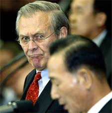 US Defence Secretary Donald Rumsfeld looks at his South Korean counterpart Cho Yung-gil during a Press conference at Seoul's Defence Ministry headquarters 