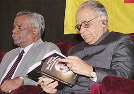 Mr T.N. Chaturvedi, Governor of Karnataka, goes through the pages of Indias Second Freedom: An Untold Saga by M.G. Devasahayan at Panjab University on Tuesday.