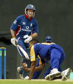 Sri Lanka's Dushana Fernando takes a diving catch off his own bowling to dismiss England's Andrew Strauss
