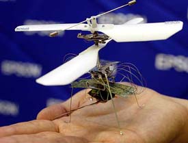 Seiko Epson Corp unveils the company's newly developed ultra-thin flying microrobot at the 2003 International Robot Exhibition in Tokyo