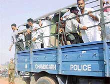Villagers being arrested after they protested against the draw of plots