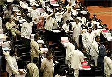 Sri Lankan opposition members of Parliament shout during the Parliament session
