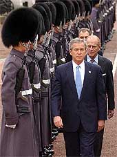 US President George W. Bush walks in front of the Duke of Edinburgh