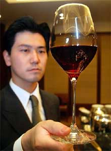 A waiter looks at this year's version of Beaujolais Nouveau wine