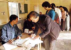 Mizoram Pradesh Congress Committee President and former Chief Minister Lalthanhawla with his wife, Lalriliani, register their names before casting votes in Aizawl on Thursday