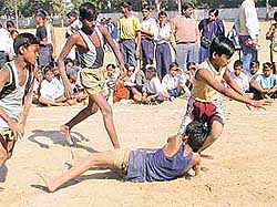 A primary school kabaddi player struggles with his opponents in the UT Inter-School Primary Games