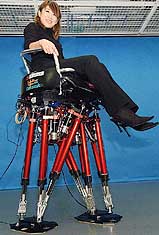 A bipedal, chair-shaped robot carries a model during its showing at Waseda University in Tokyo on Friday. The motor-driven robot, developed by the university and Japanese robotics firm tmsuk Co, can walk at a speed of about 1 km per hour