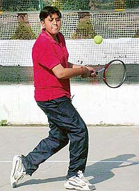 A player executes a backhand stroke in the Satluj Open Tennis Tournament at Satluj Public School, Sector 4, Panchkula