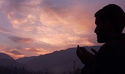 A Kashmiri Muslim prays at dusk after his day-long fast during the holy month of Ramzan in Srinagar