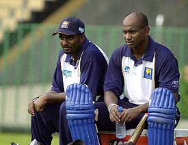 Sri Lanka's Muttiah Muralitharan and Sanath Jayasuriya take a break during a practice session at Premadasa Stadium in Colombo