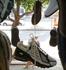 A Vietnamese shoe vendor waits for customers in Ho Chi Minh City, Vietnam