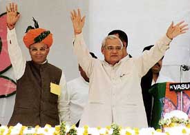 Prime Minister Atal Bihari Vajpayee waves to the crowd at an election rally in Jodhpur