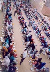 Devotees partake langar at a gurdwara in connection with Martyrdom Day of Guru Teg Bahadur